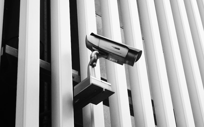 a security camera mounted to the side of a building